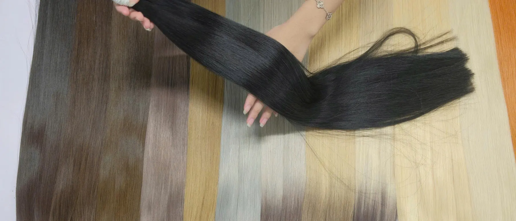 Our shade range laid out in the workshop, from natural black through browns and ash tones to platinum blonde