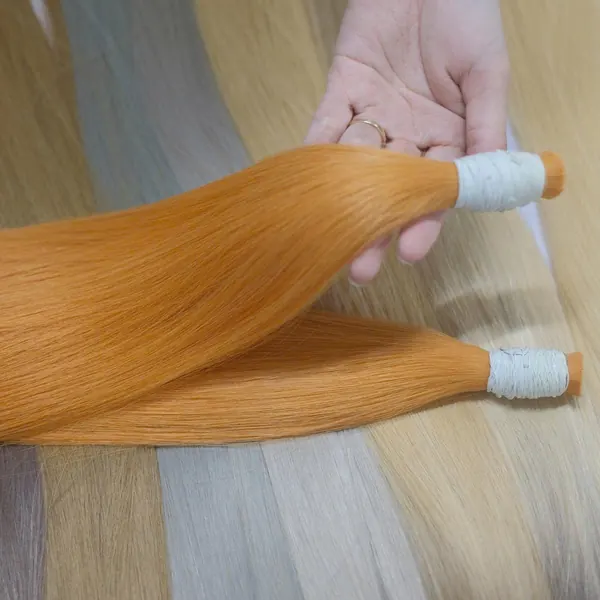 Copper-dyed bundles held over the shade range