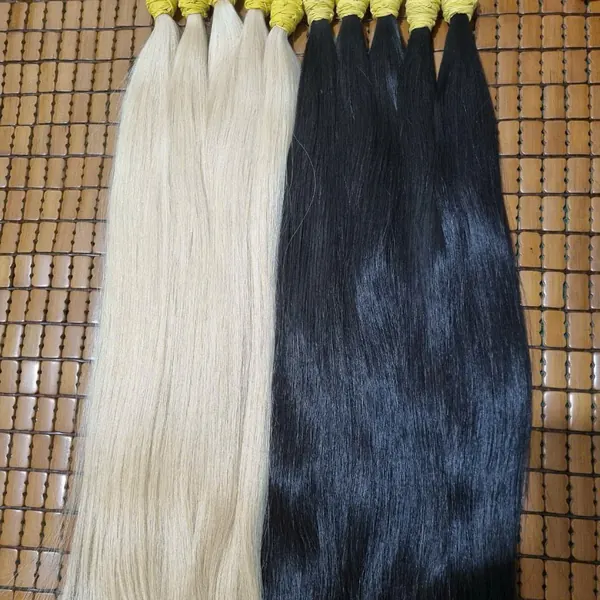 Platinum and black bundles side by side on a bamboo mat